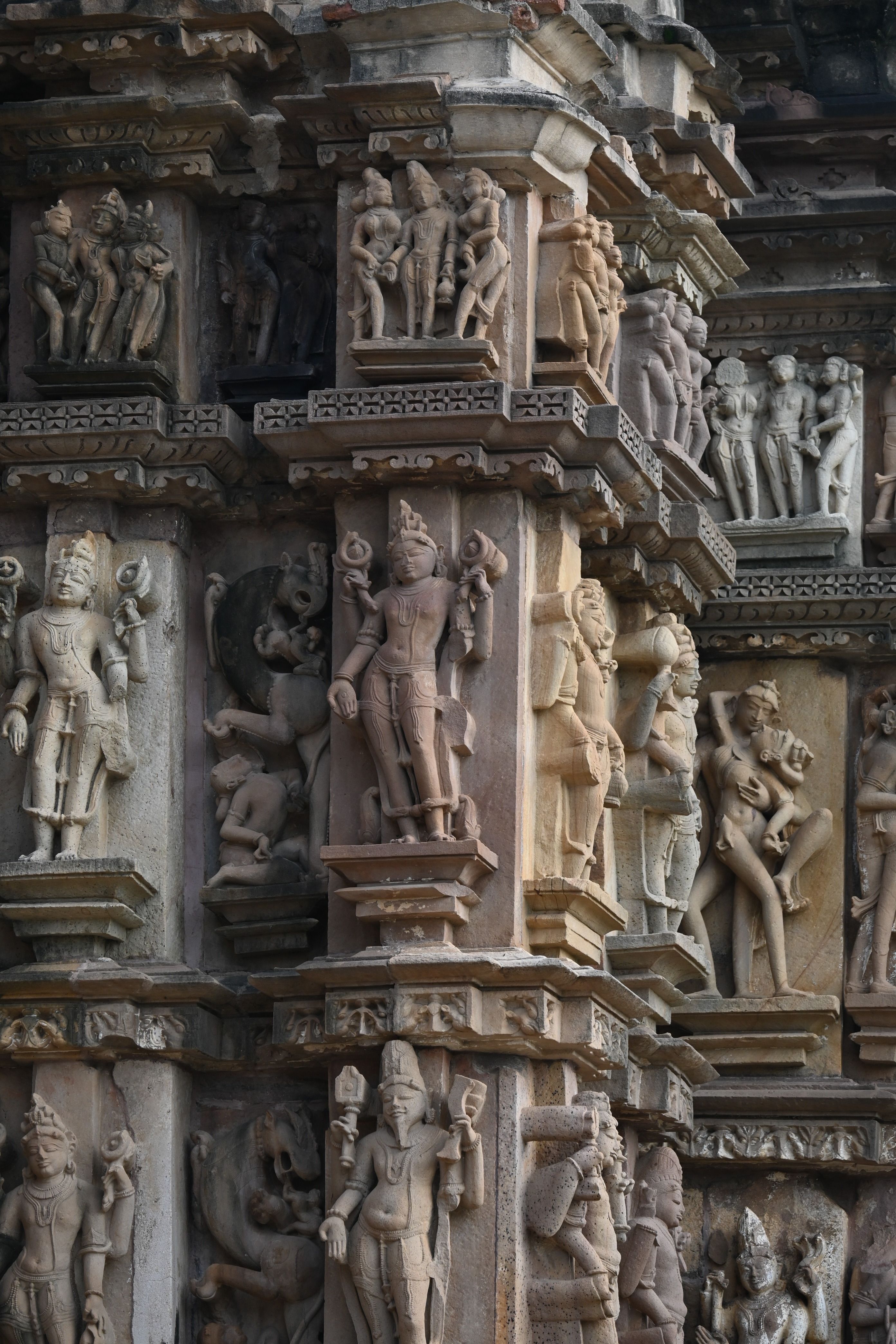 Detailed carvings on ancient Khajuraho temple showcase exquisite artistry and Indian cultural heritage.