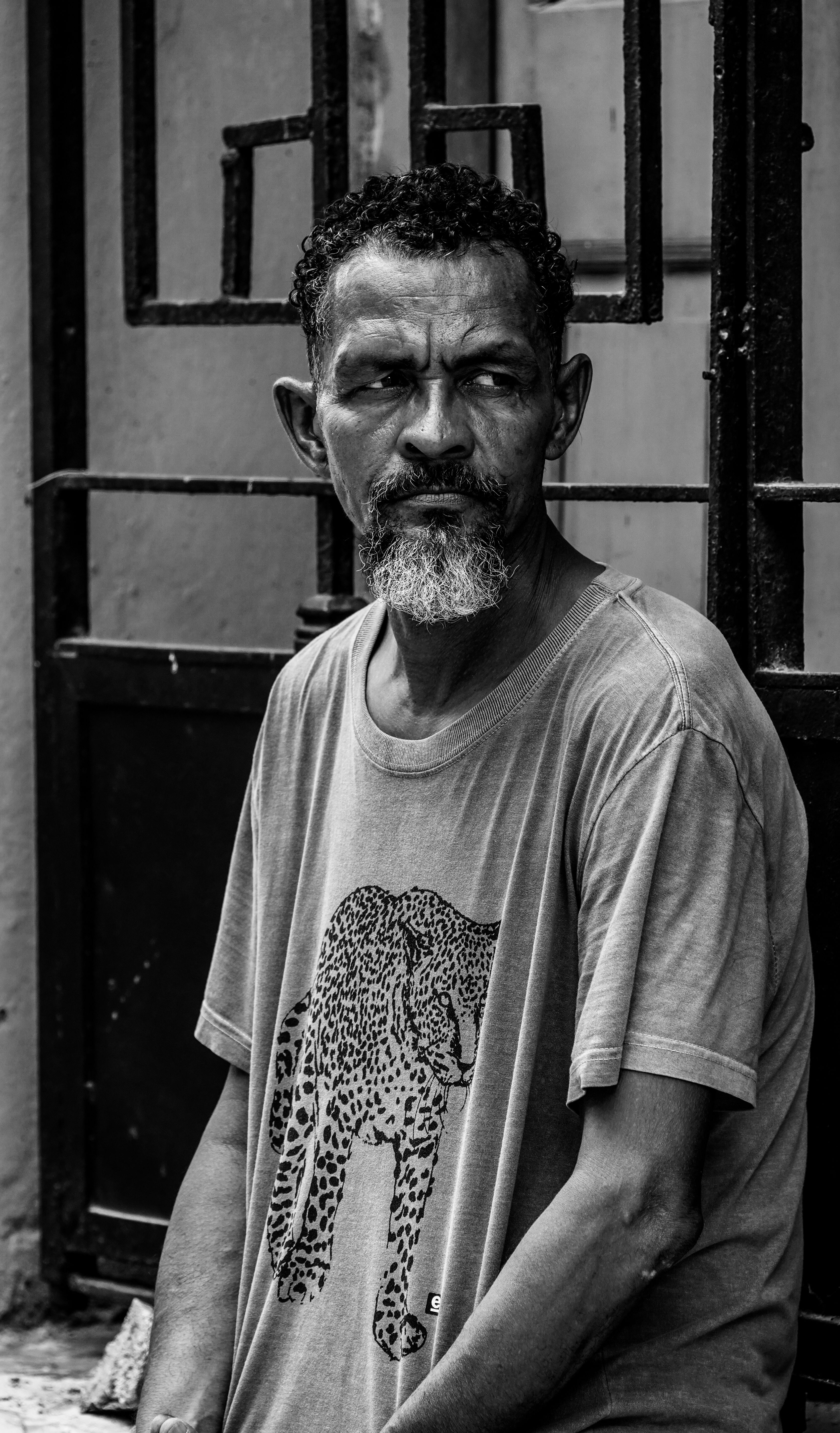 Black and white portrait of a thoughtful man in La Habana, Cuba, exuding a timeless and introspective vibe.