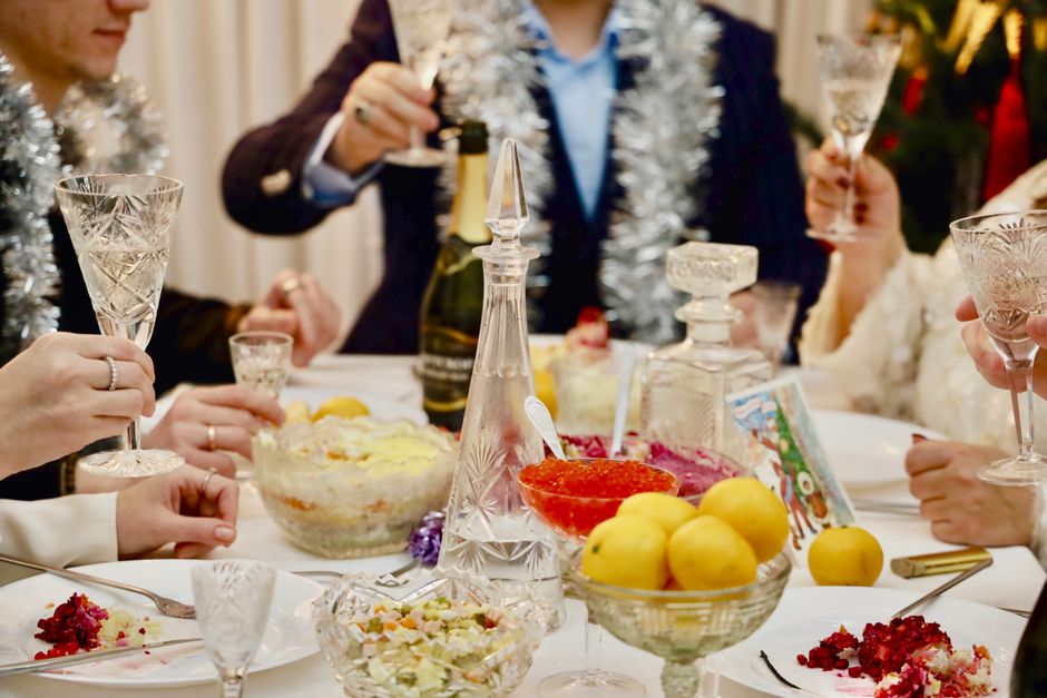 Holiday dining spread with champagne toast and festive dishes Holiday dining spread with champagne toast and festive dishes