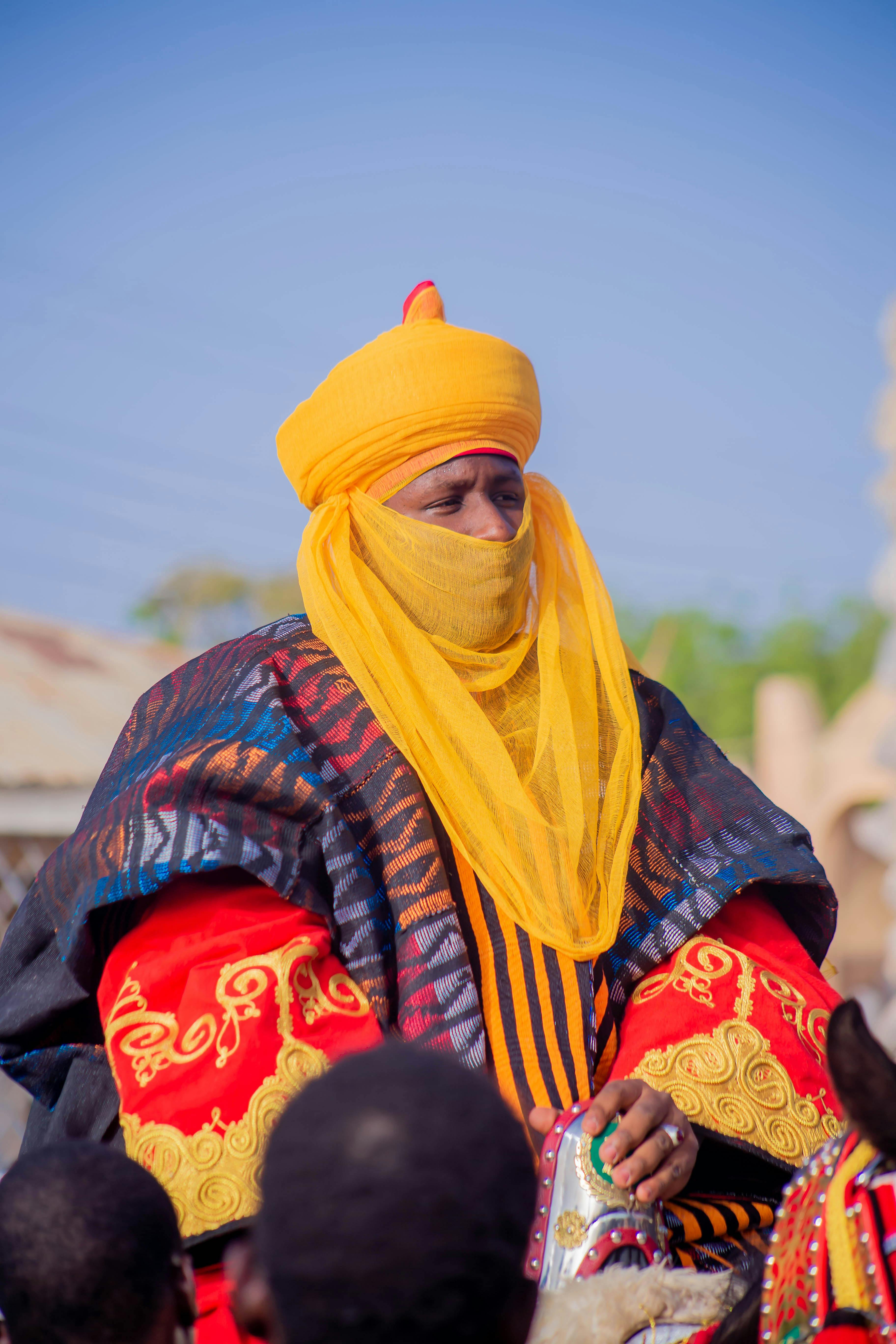 Man dressed in vibrant traditional African attire during a cultural event.