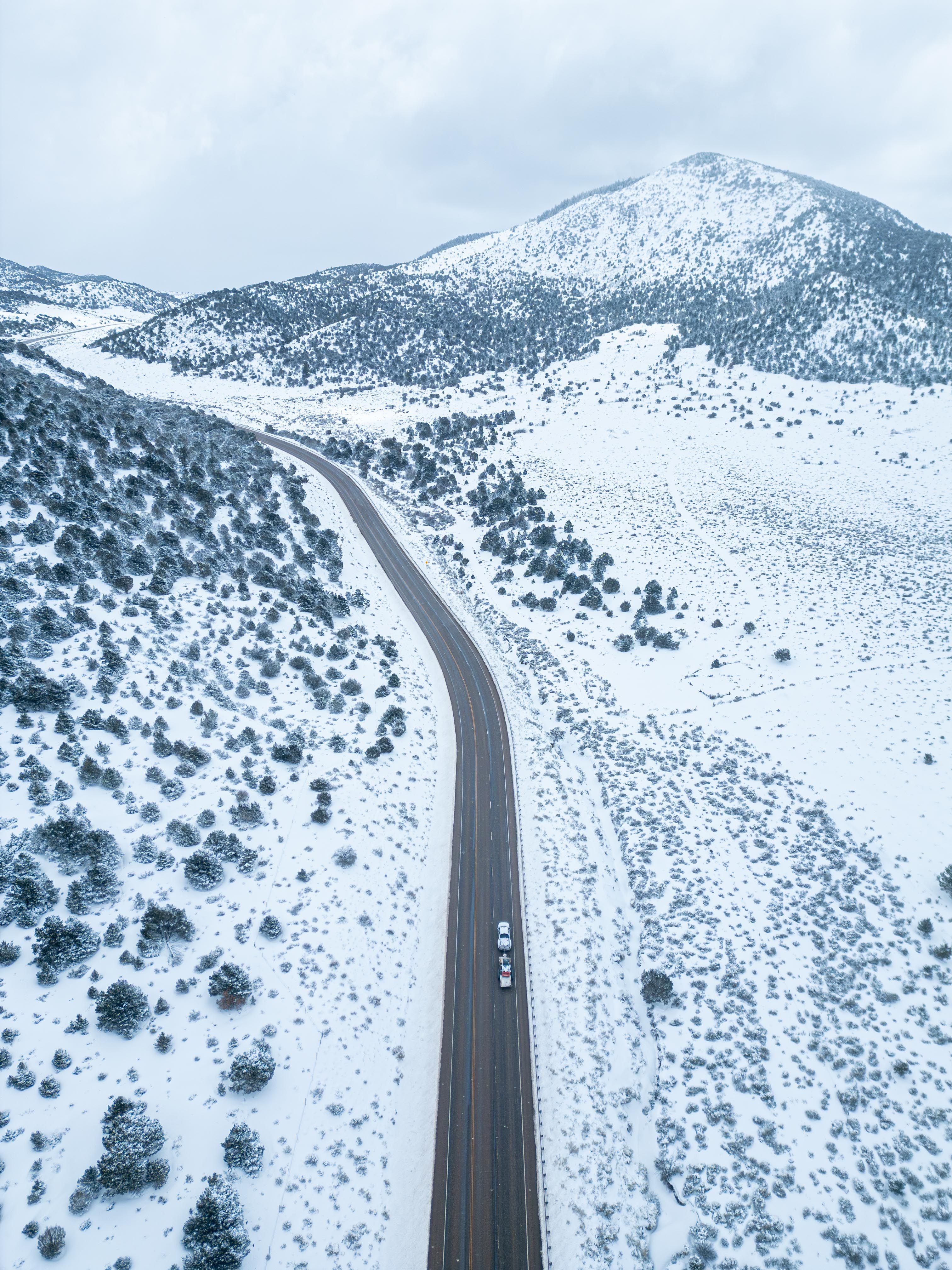 Aerial View of Snowy Mountain Road in Winter · Free Stock Photo
