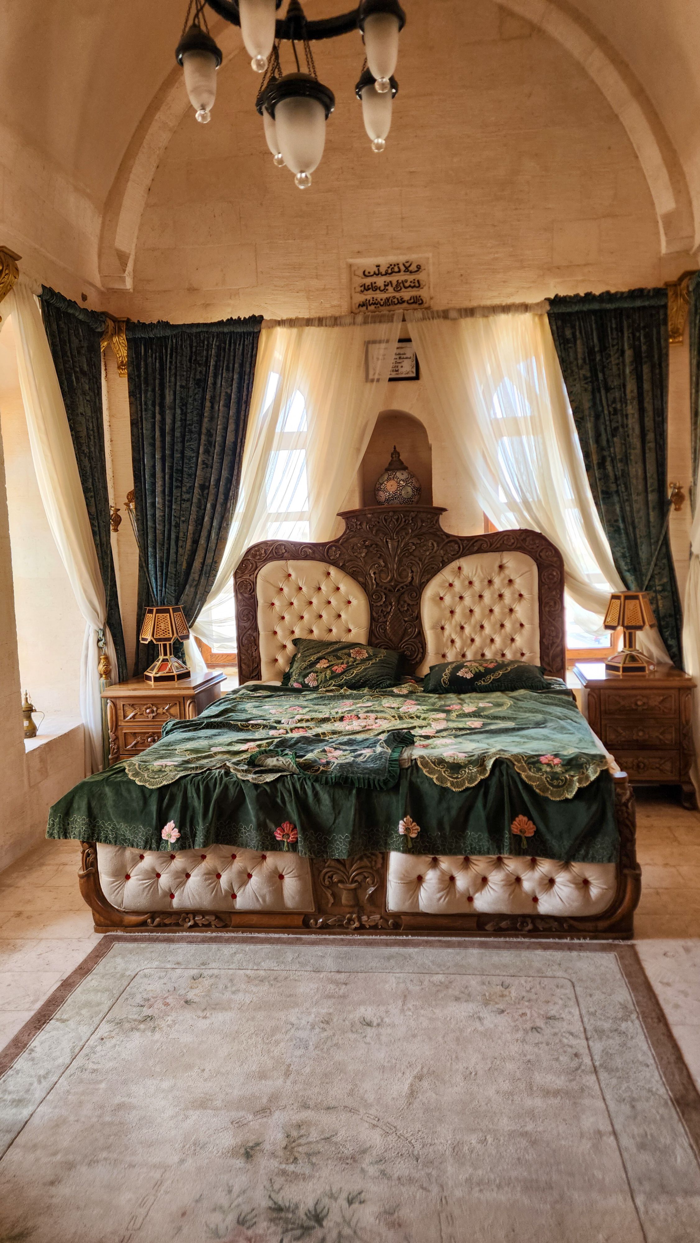 Elegant vintage bedroom with ornate furniture and rich drapery.