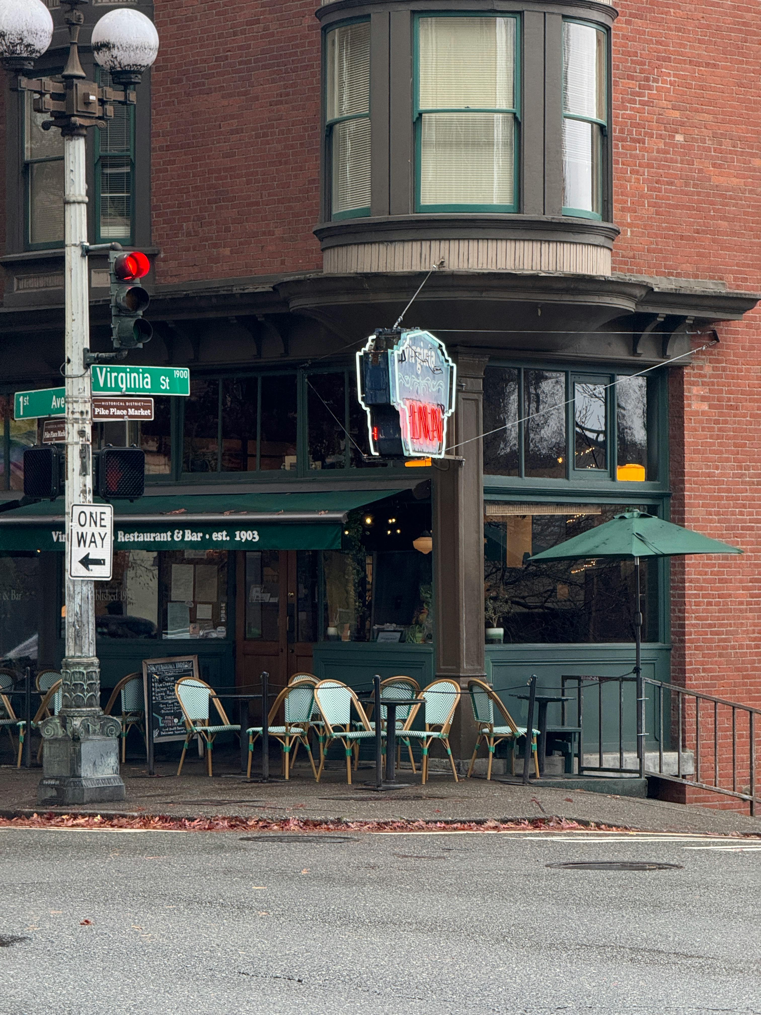 Free Quaint cafe on a street corner, capturing urban charm and history. Stock Photo