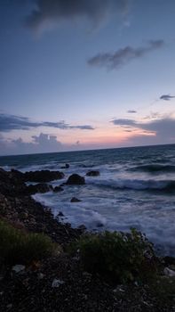 Breathtaking twilight scene of a rocky coastline in Turkey with captivating waves.