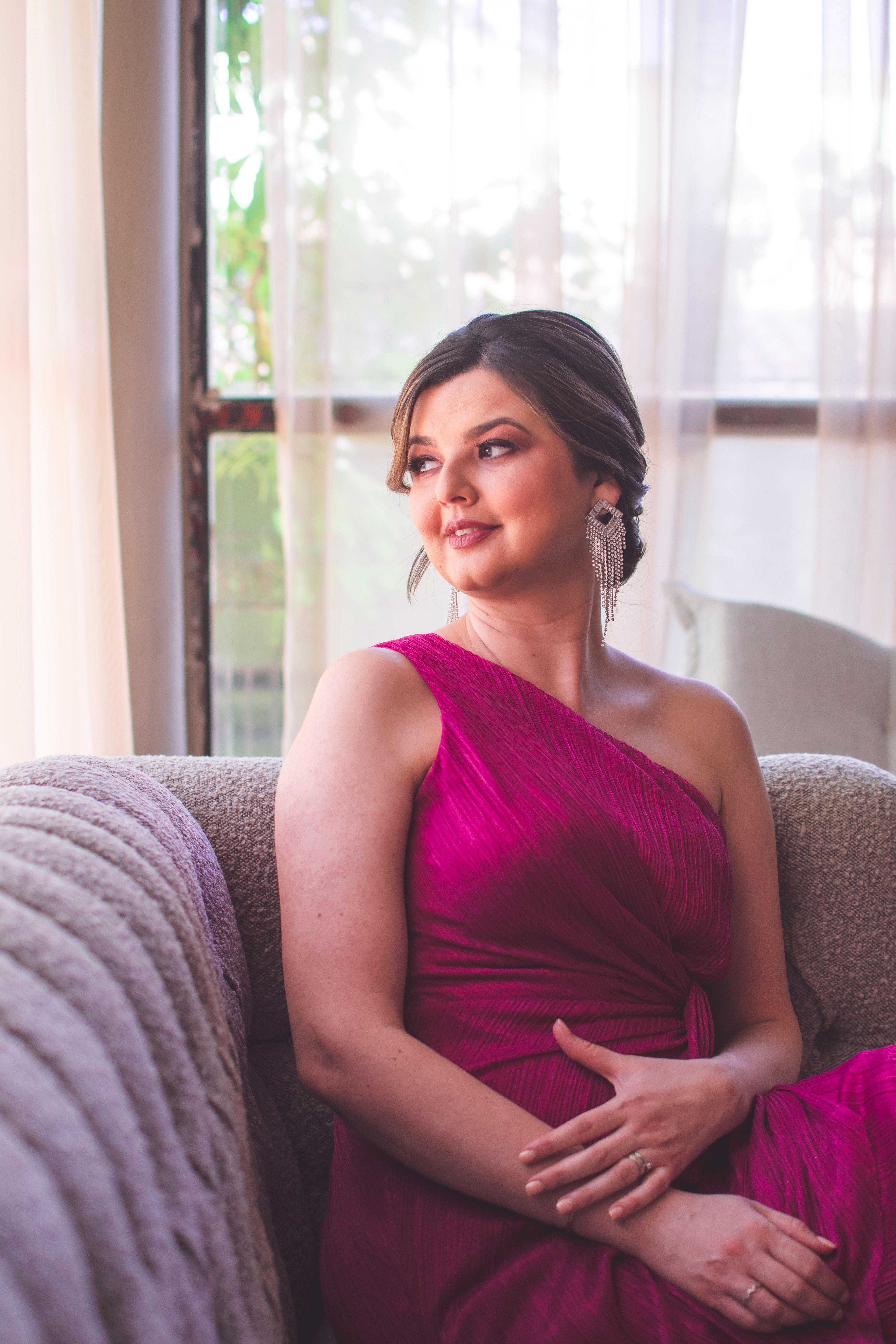 Elegant Woman in Pink Dress Sitting Indoors · Free Stock Photo