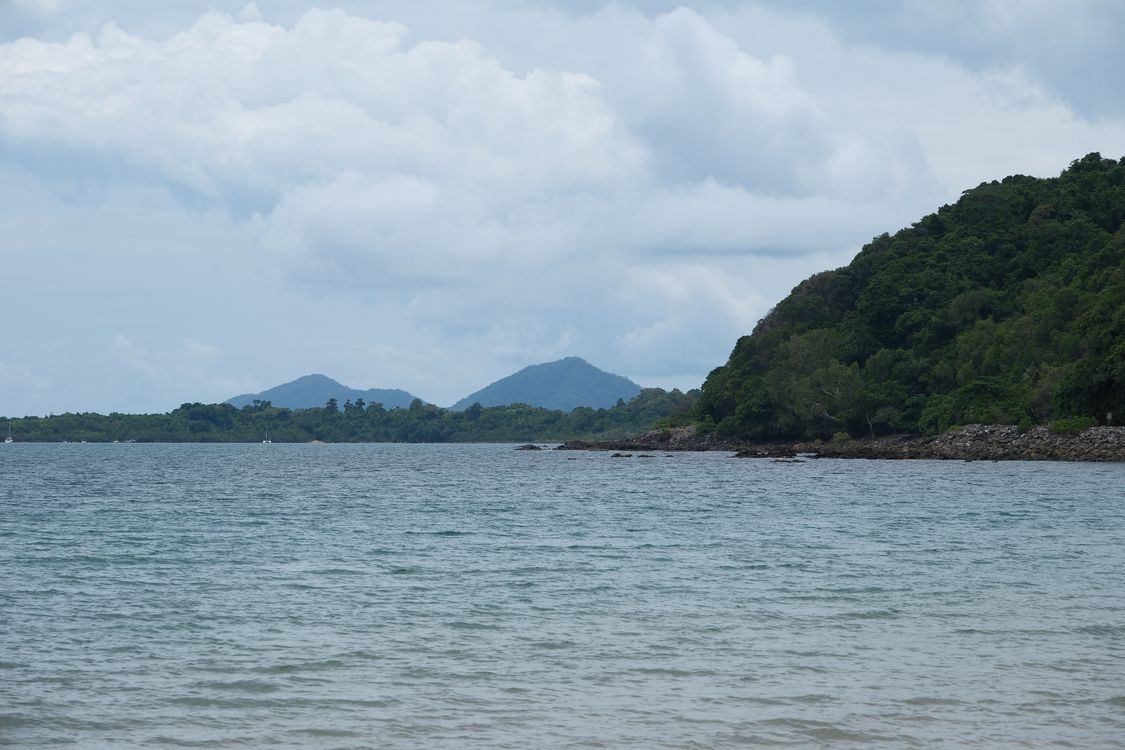 Serene Coastal Landscape with Lush Green Hills · Free Stock Photo