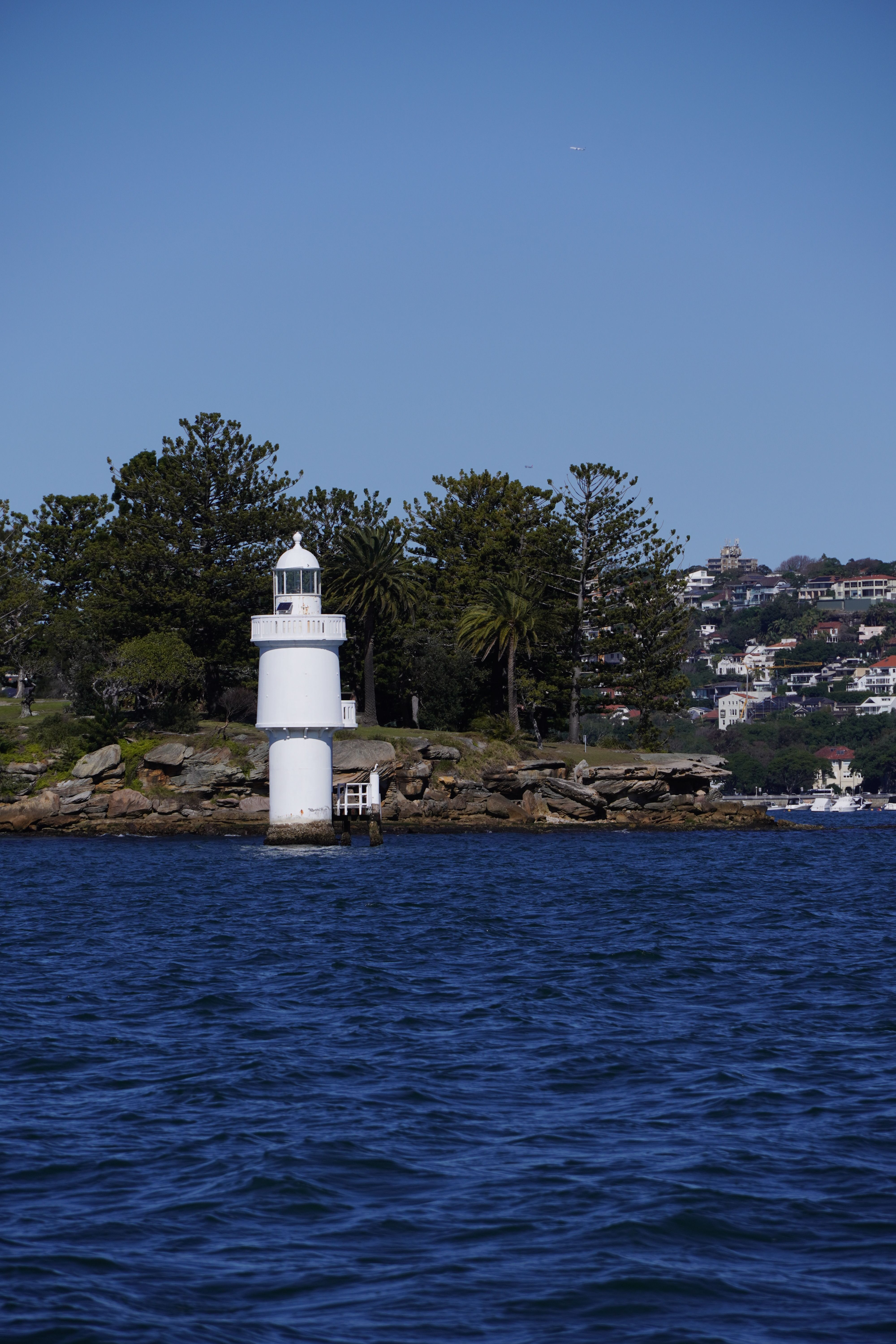 Stunning view of a Sydney lighthouse on a sunny day, overlooking the sea.