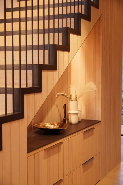 Photo by Wanshan Luo on Pexels Stylish wooden staircase corner with elegant decor in a modern Wanaka home.