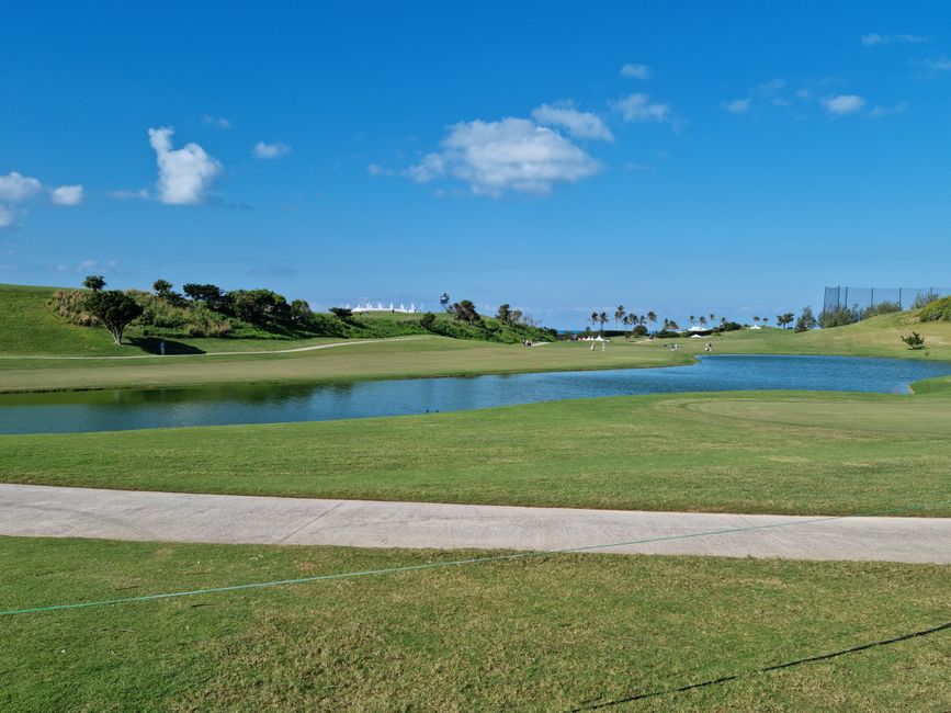Photo by Daniel T Serene view of a lush green golf course under a bright blue sky with picturesque clouds.