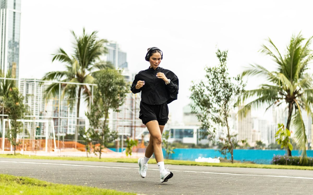 A woman enjoying a morning run in a vibrant park in Panama City, Panama.