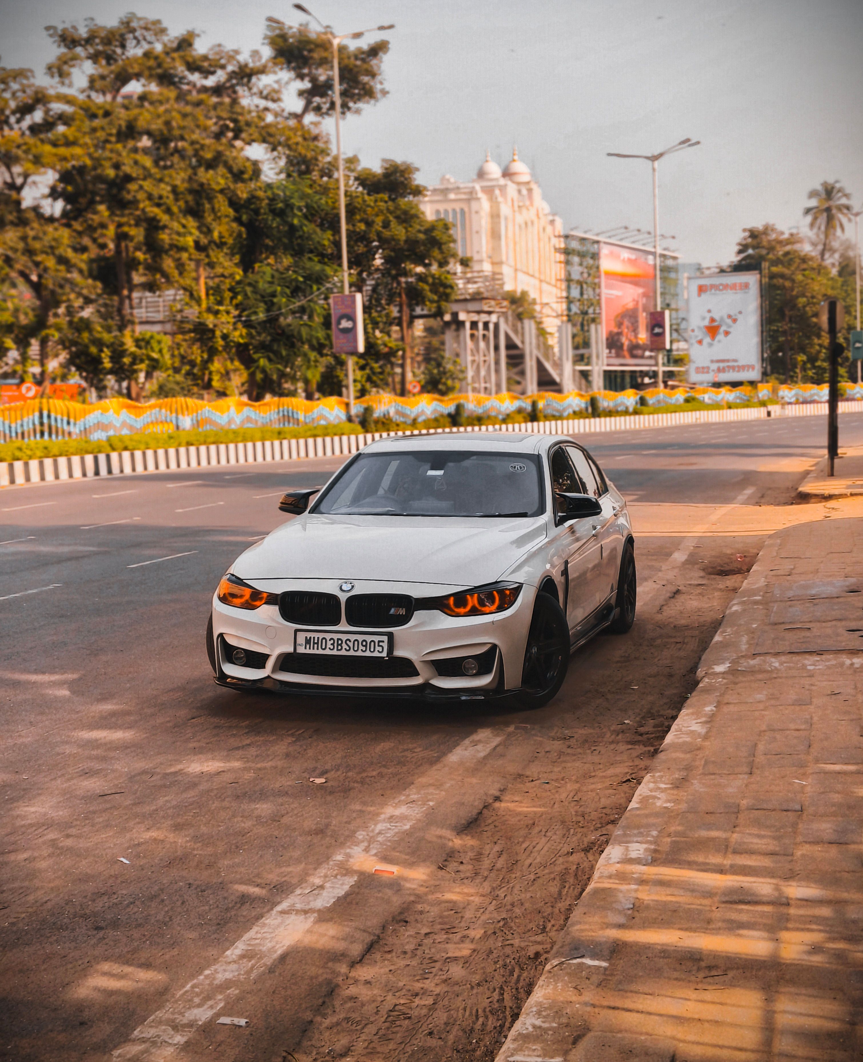White Car Parked on Urban Road at Daytime · Free Stock Photo