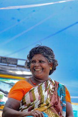 Portrait of a smiling woman in a colourful sari.