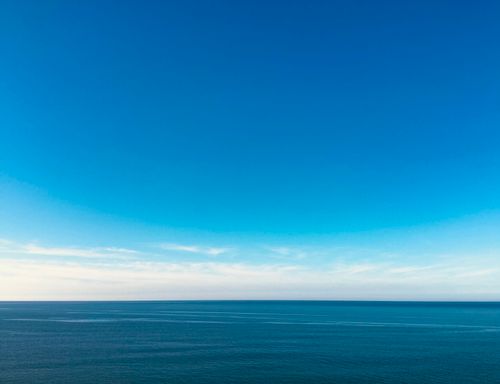 Free Peaceful ocean view under a clear blue sky, ideal for relaxation themes. Stock Photo