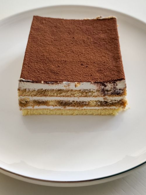 Free A close-up of a classic tiramisu slice showcasing its creamy layers. Stock Photo