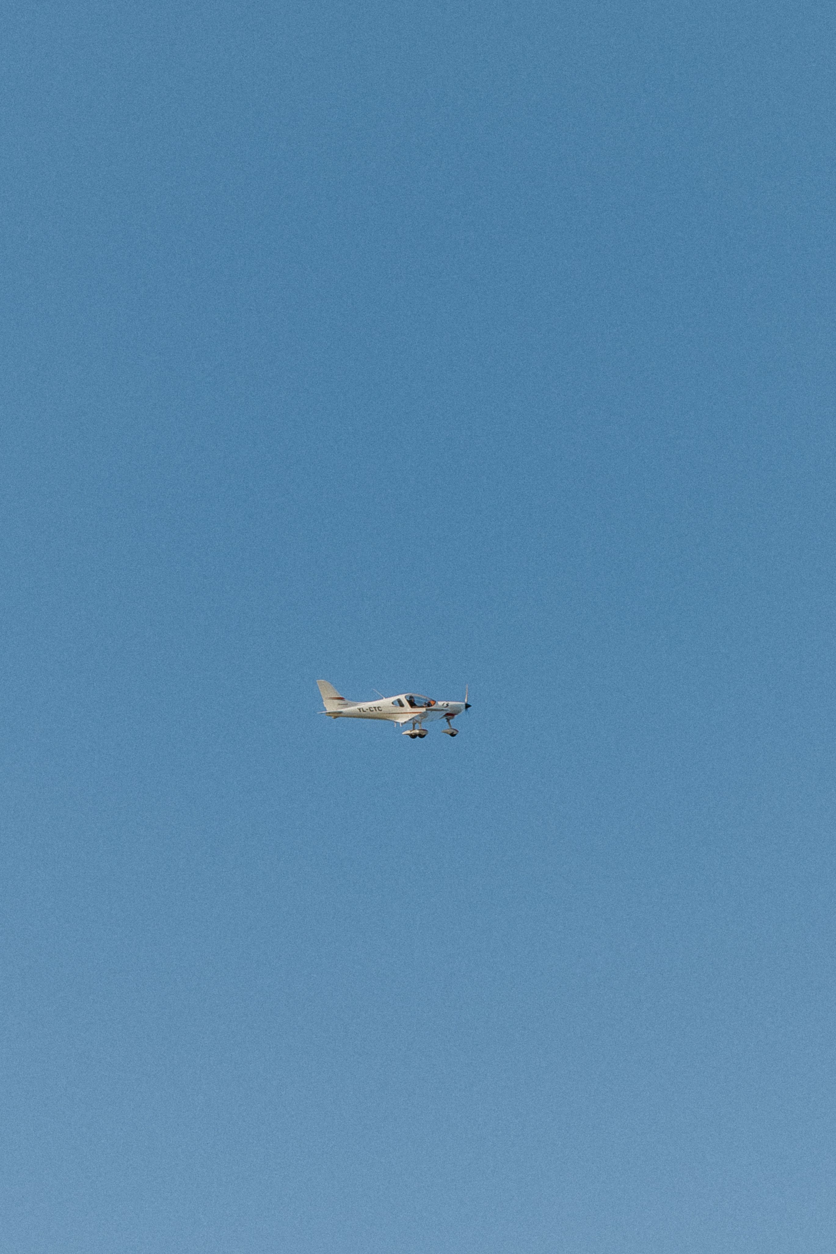 Small Airplane Flying in Clear Blue Sky · Free Stock Photo