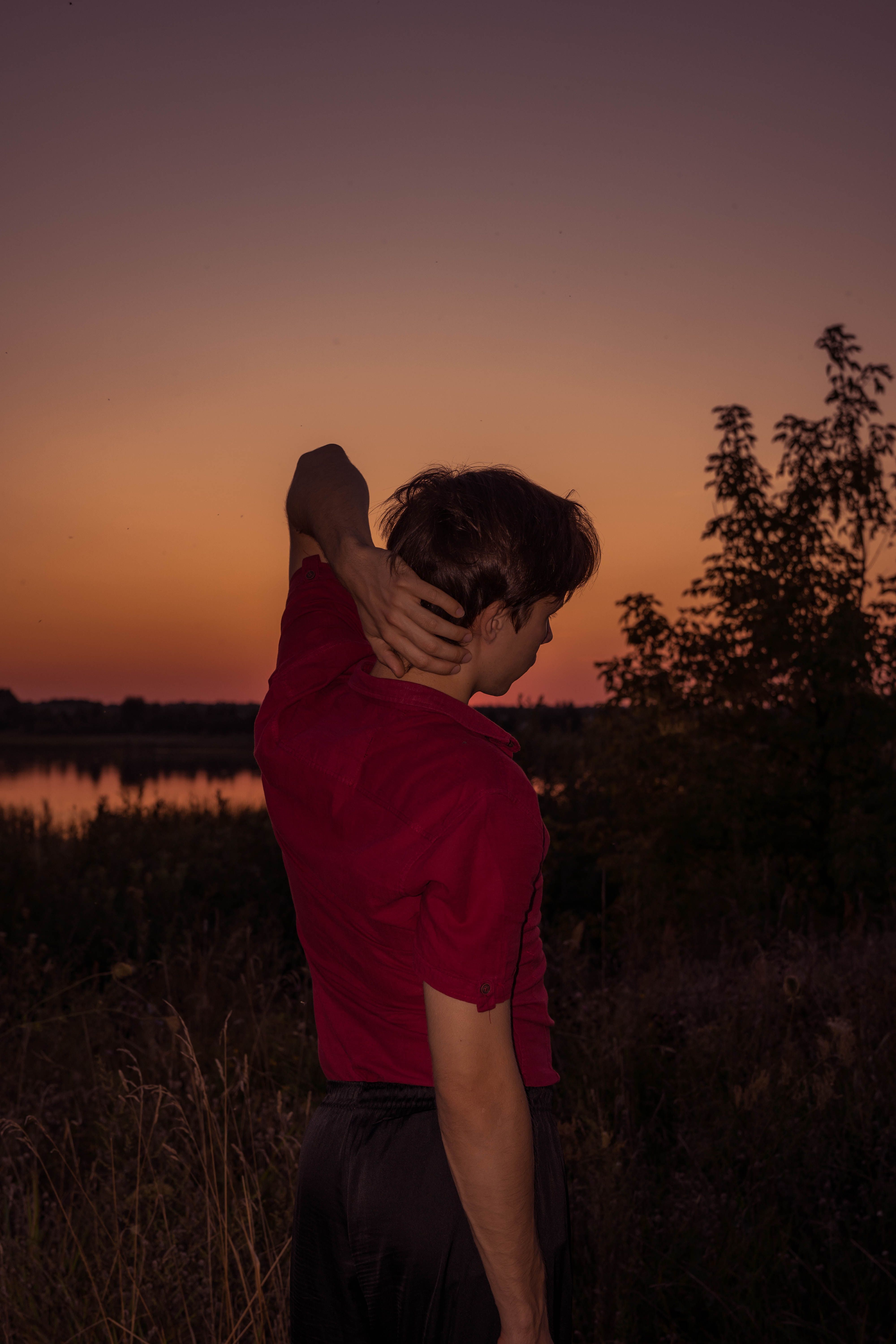 Contemplative Person at Sunset by the Lake · Free Stock Photo