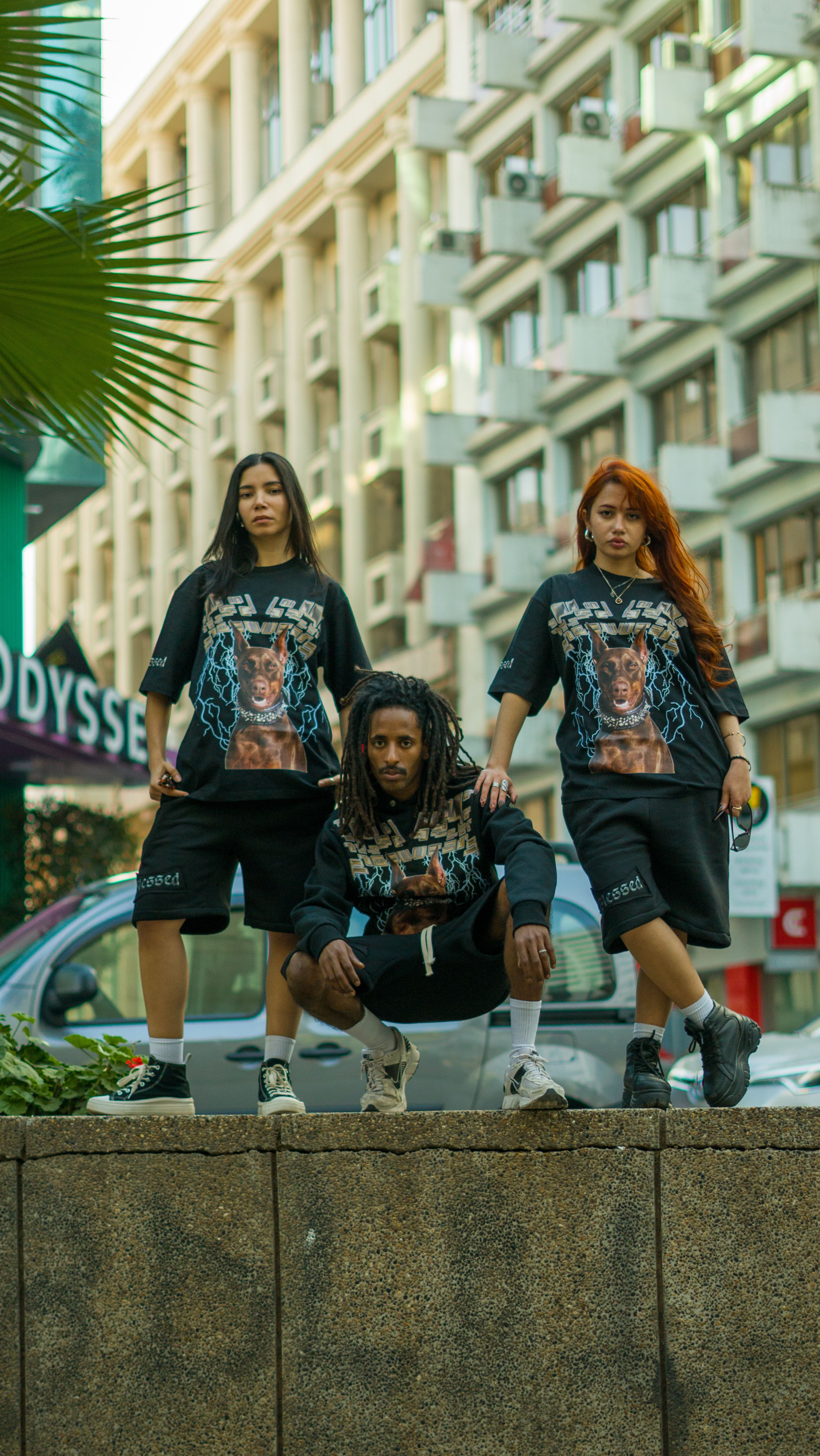 Three diverse adults pose in fashionable streetwear in Casablanca, showcasing urban style.