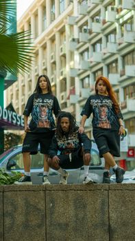 Three diverse adults pose in fashionable streetwear in Casablanca, showcasing urban style.