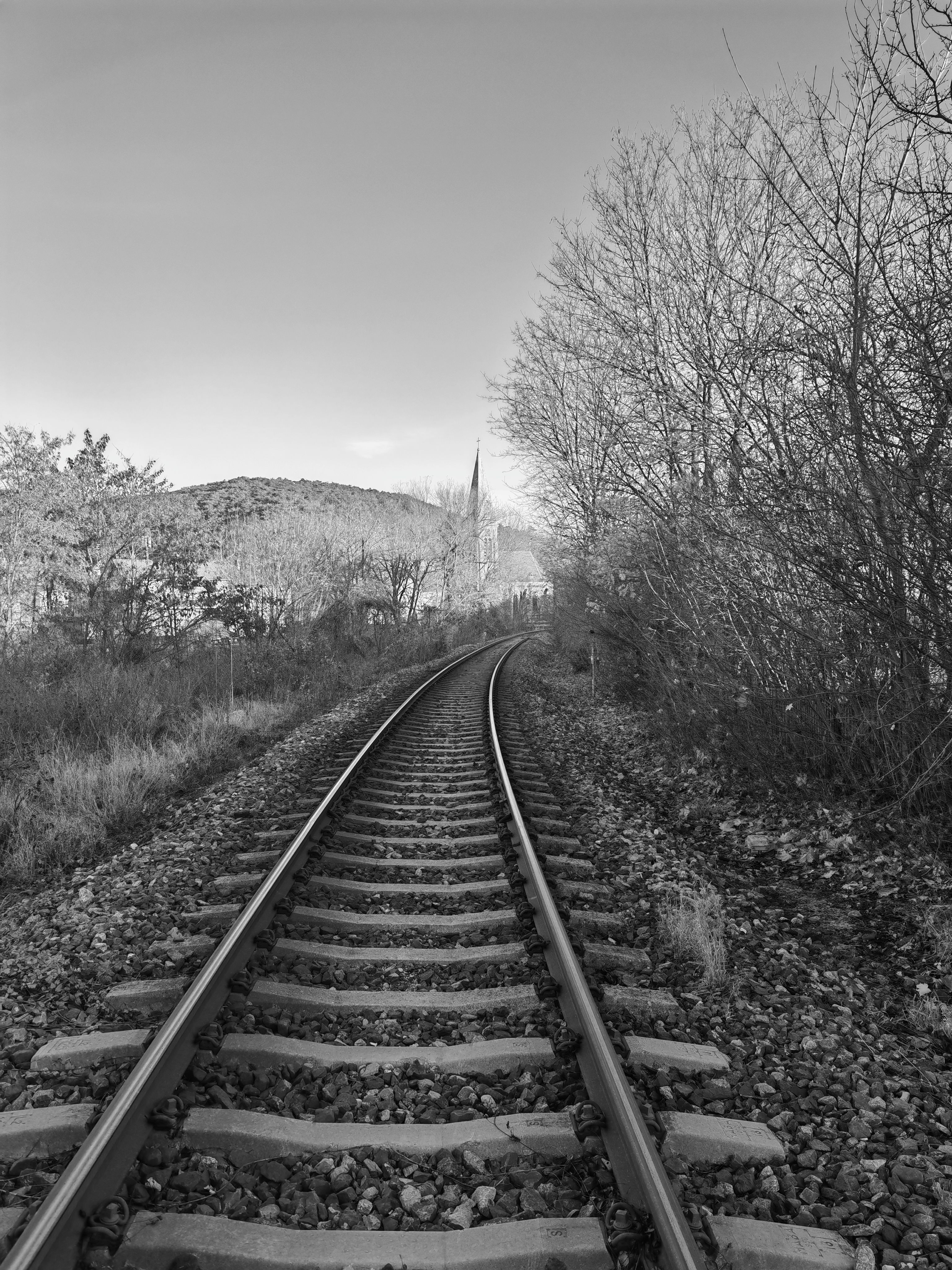 Scenic Railroad Track Leading to Distant Spire · Free Stock Photo