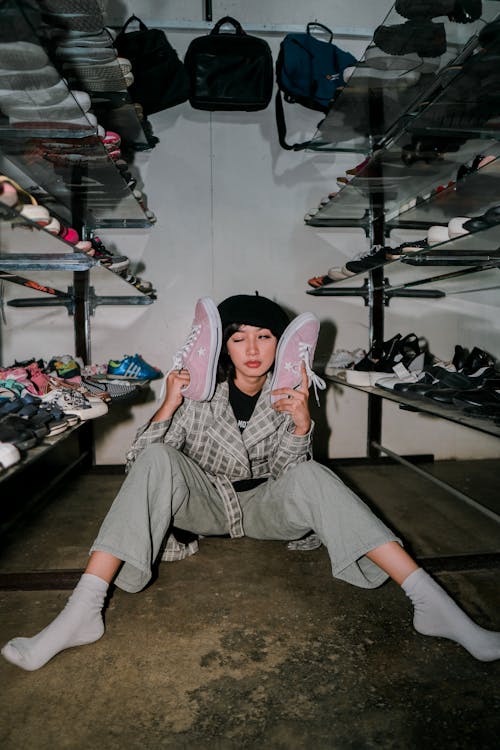 Eccentric woman with shoes in wardrobe