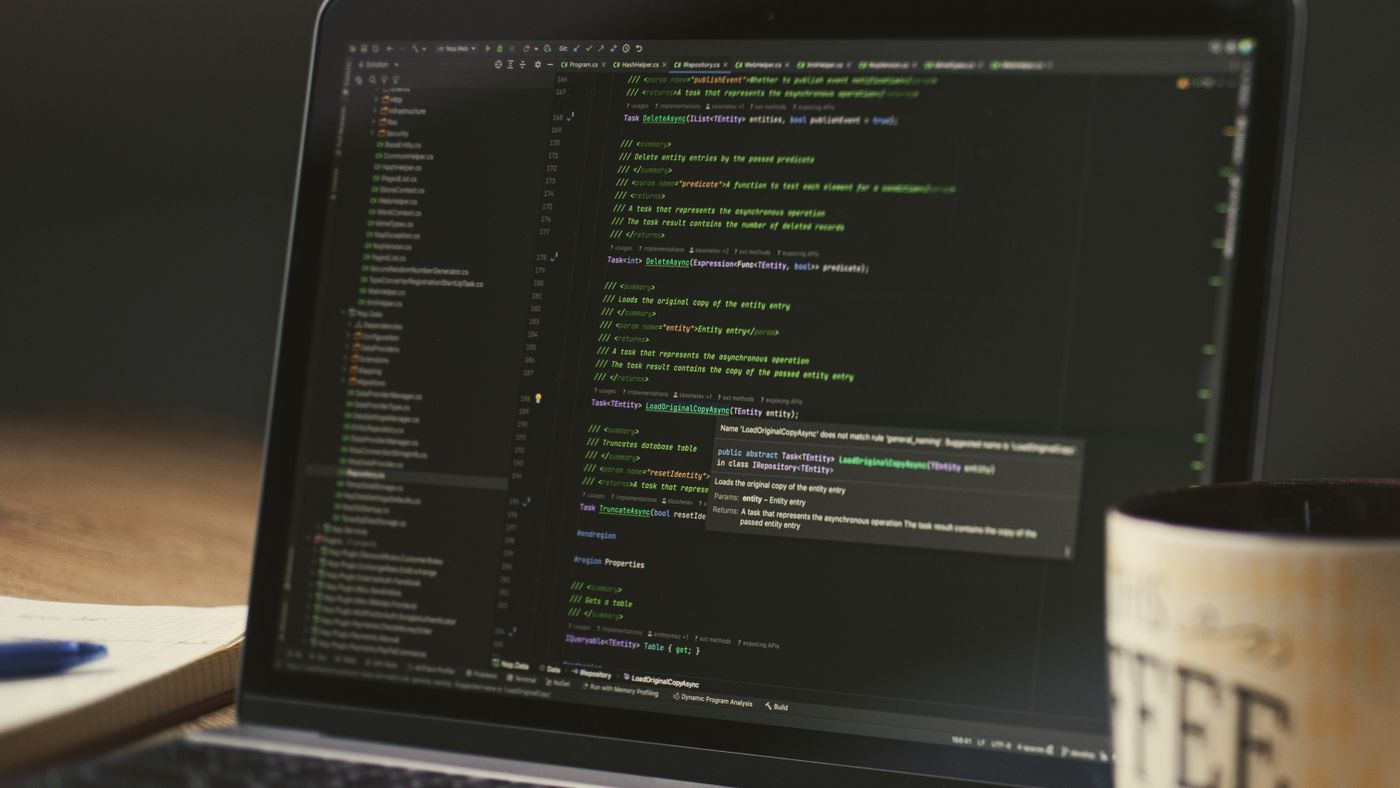 Logs and the Reachability report settle most arguments about where a failure actually is. Photo: Daniil Komov / Pexels; illustrative. Laptop on a desk showing a code editor with a coffee mug beside it