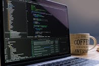 Laptop with Coding Software and Coffee Mug