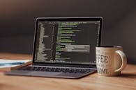 Modern Workspace with Coding Laptop and Coffee