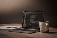 Cozy Workspace with Coding on Laptop Screen