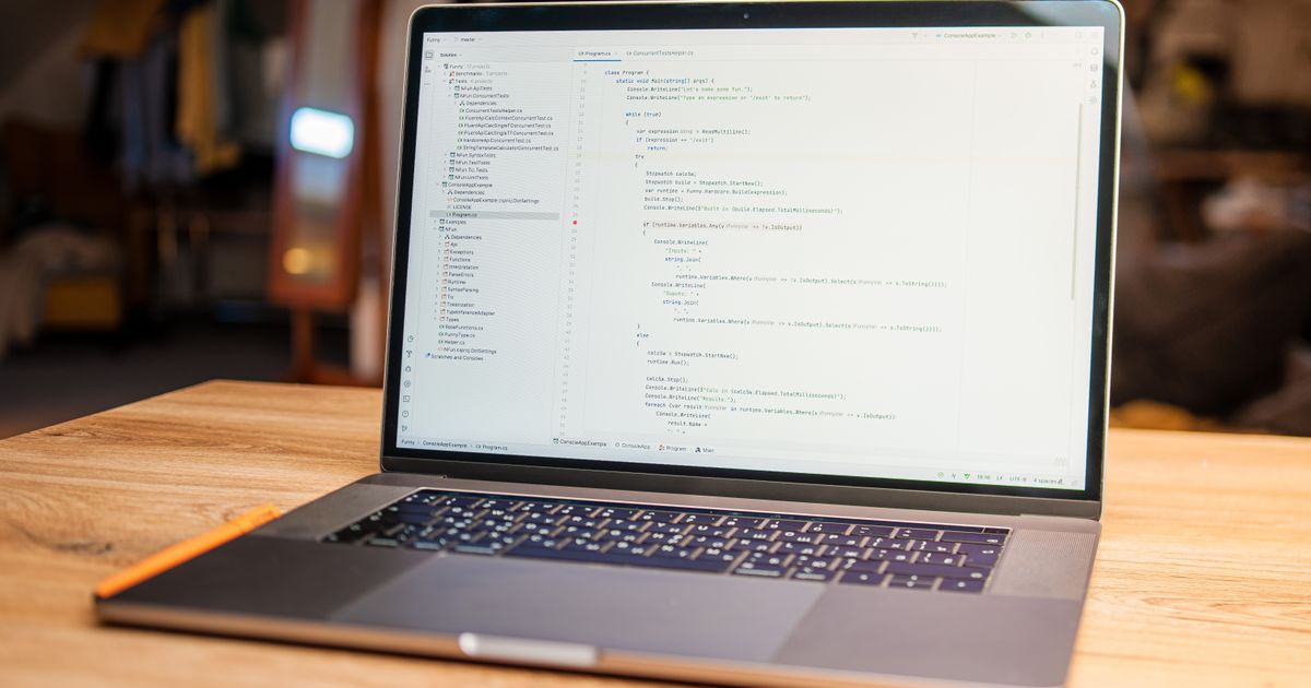 Immigration Salary List UK 2026: Thresholds, Eligibility & Phase-Out — Open laptop with visible code on screen on a wooden desk in a modern, cozy workspace.