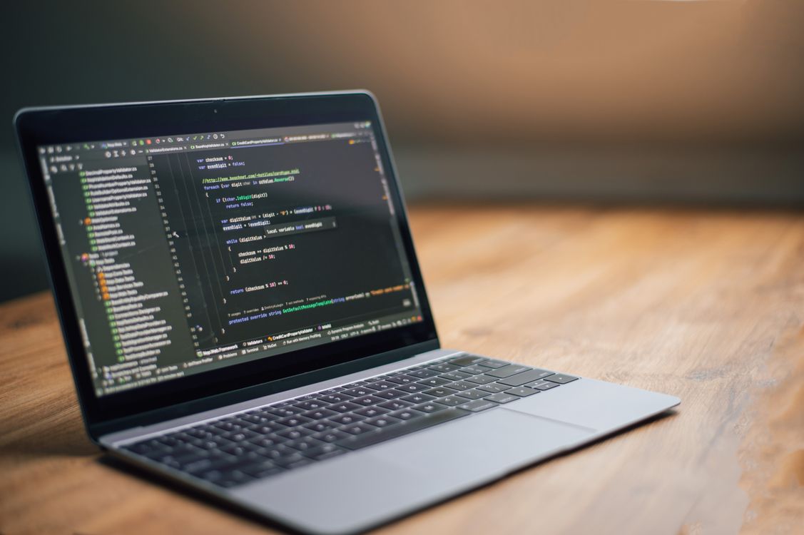 Open Laptop with Software Code on Screen · Free Stock Photo