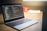 Modern Workspace with Laptop and Code Display