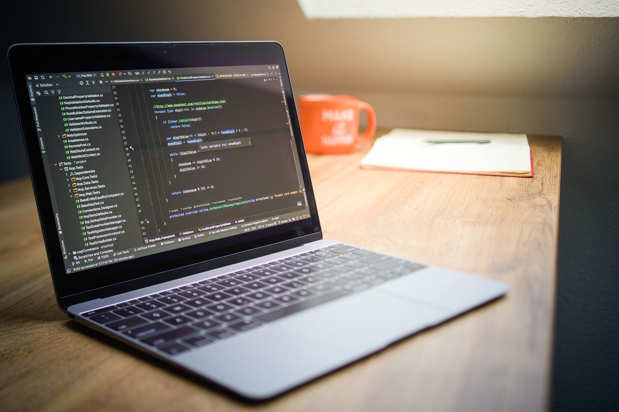 Laptop showing code on a modern desk setup