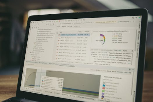 A close-up view of a laptop screen showing a coding and data analysis software interface in an indoor setting.