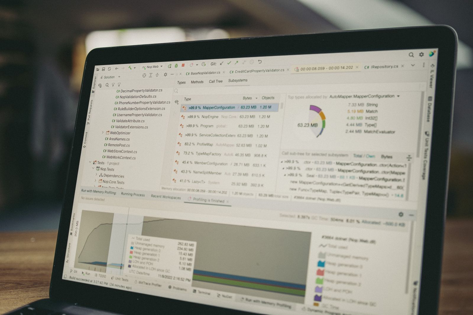 Laptop screen showing a multi-column software data table and pie chart
