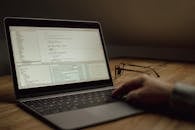 Working on code with laptop indoors