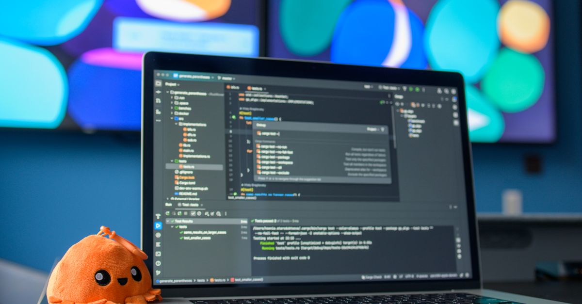 Colorful workspace featuring a laptop with code editor and vibrant screens.