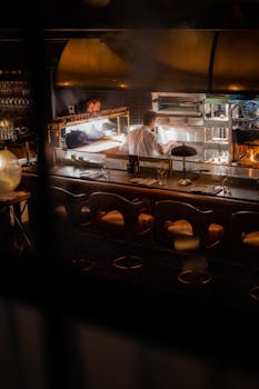 Warm and inviting view of a bustling restaurant kitchen in Dublin captured at night.