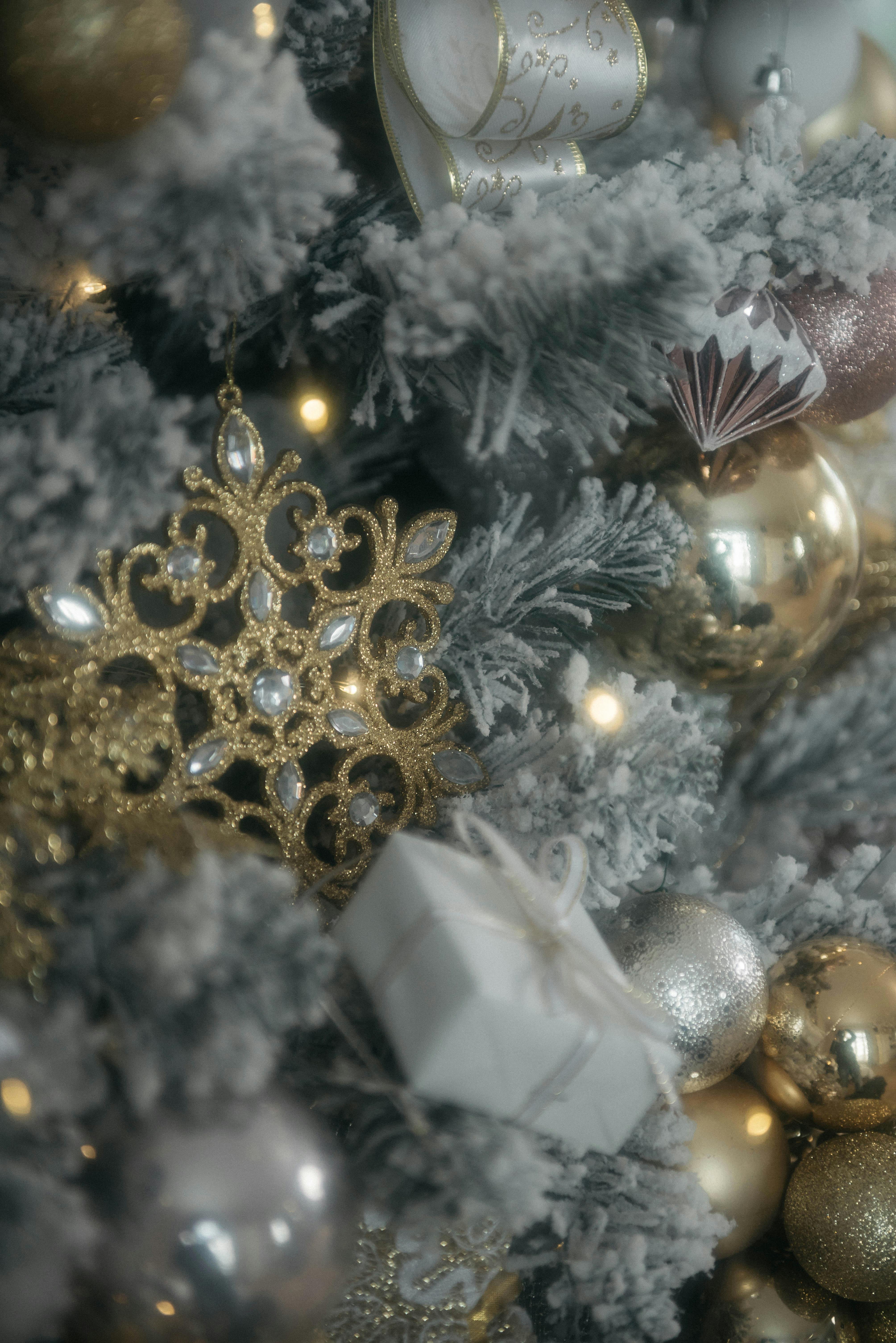 Close-up of a beautifully decorated Christmas tree with gold ornaments and gifts.
