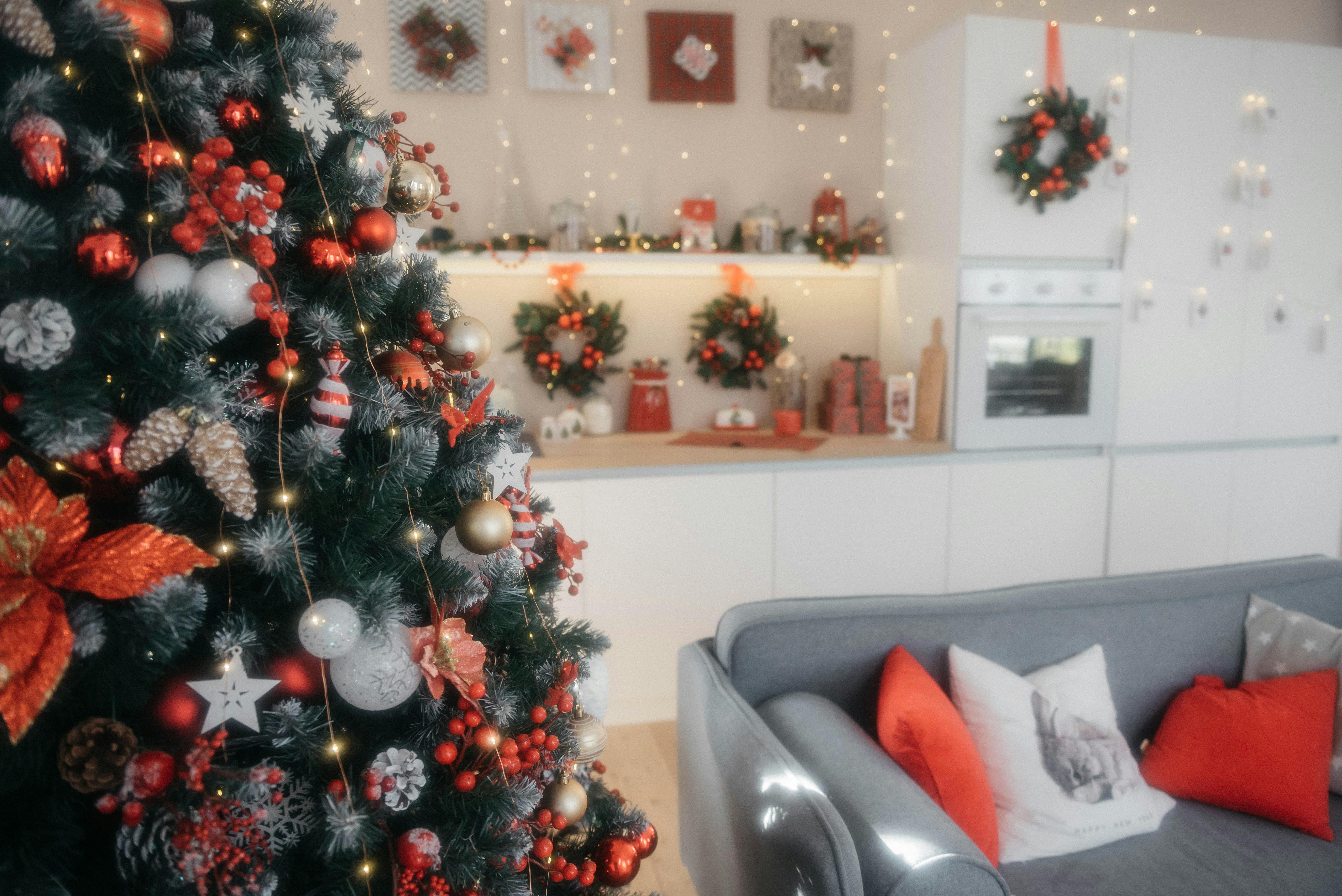 A beautifully decorated living room with a Christmas tree and festive lights, creating a cozy holiday atmosphere.