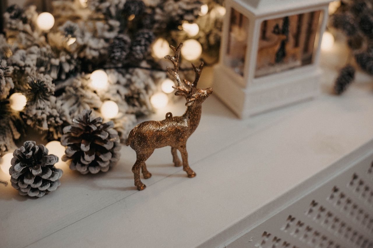 cozy winter decor with pinecones lights and reindeer ornament on a man