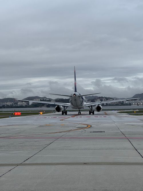 Free Airplane on runway ready for takeoff against overcast sky. Stock Photo