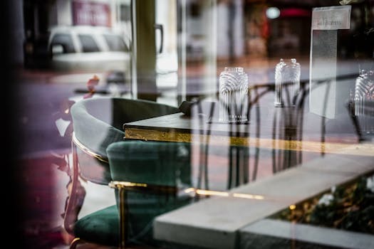 Chic cafe interior with glass reflections and elegant decor.