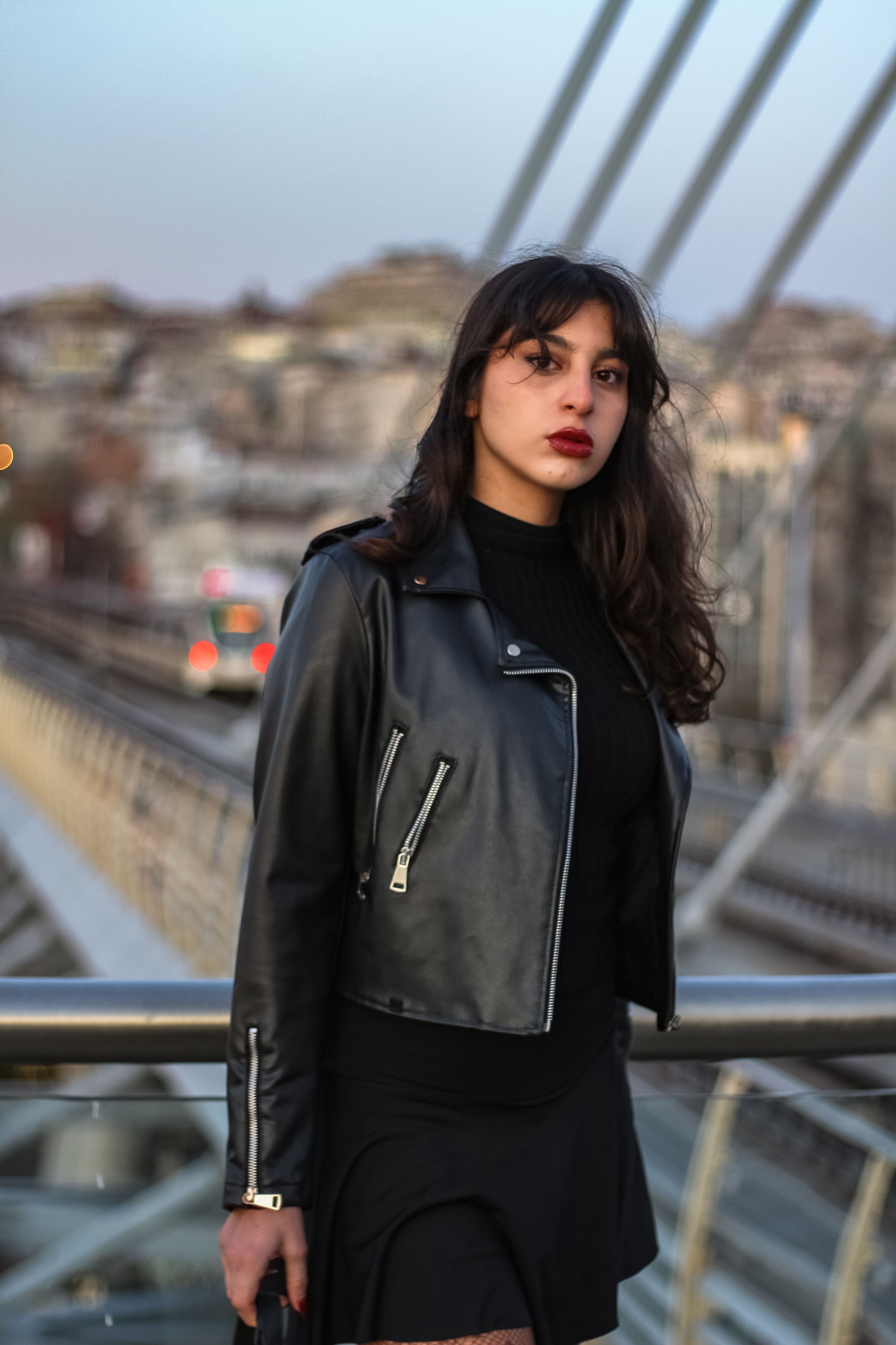 Young Woman in a Skirt and Leather Jacket Standing on the Street · Free ...