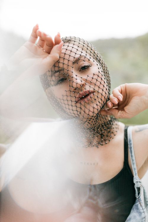 Artistic Portrait of Woman with Net Headpiece Outdoors · Free Stock Photo