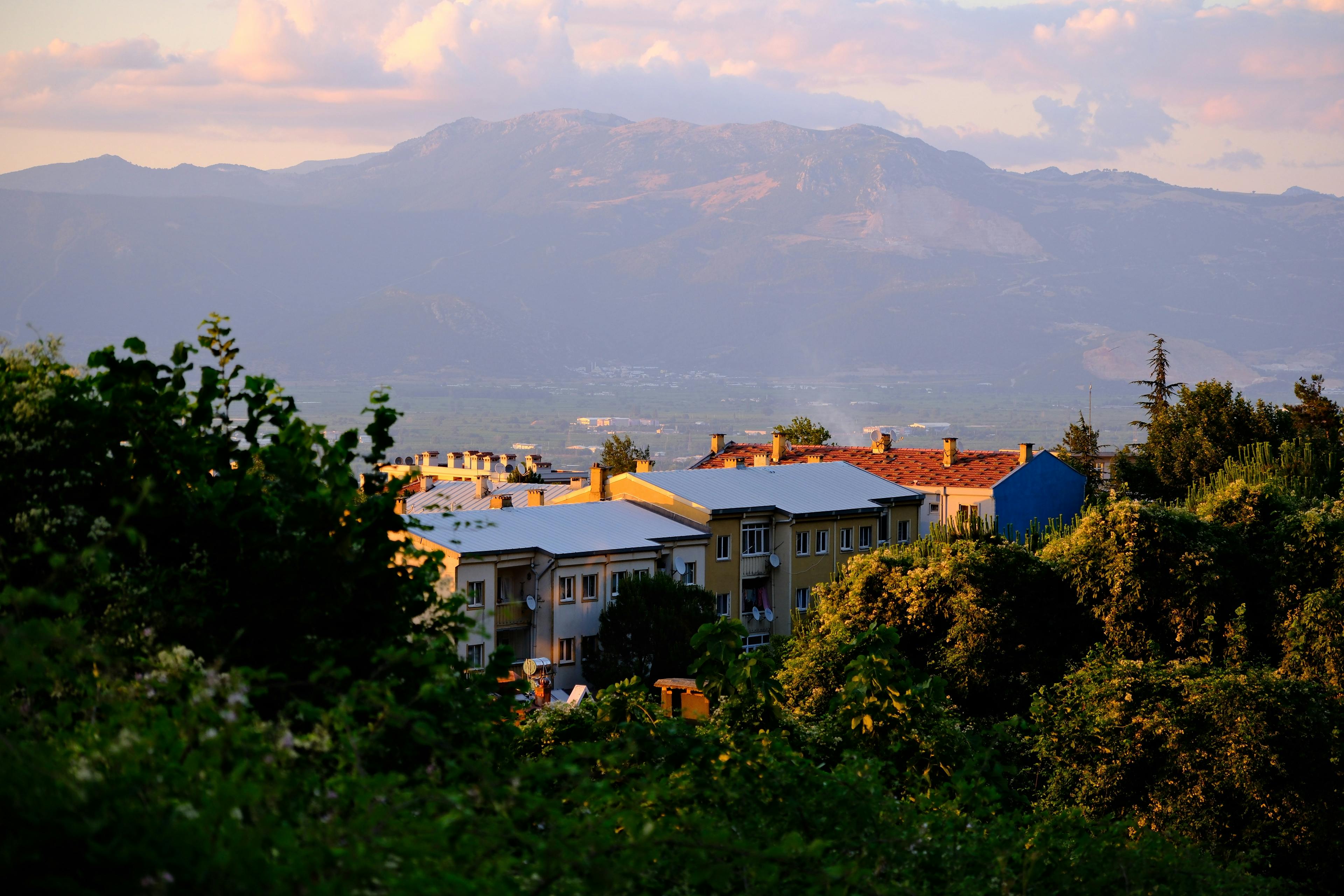Picturesque scenery of residential area with mountains at sunset.