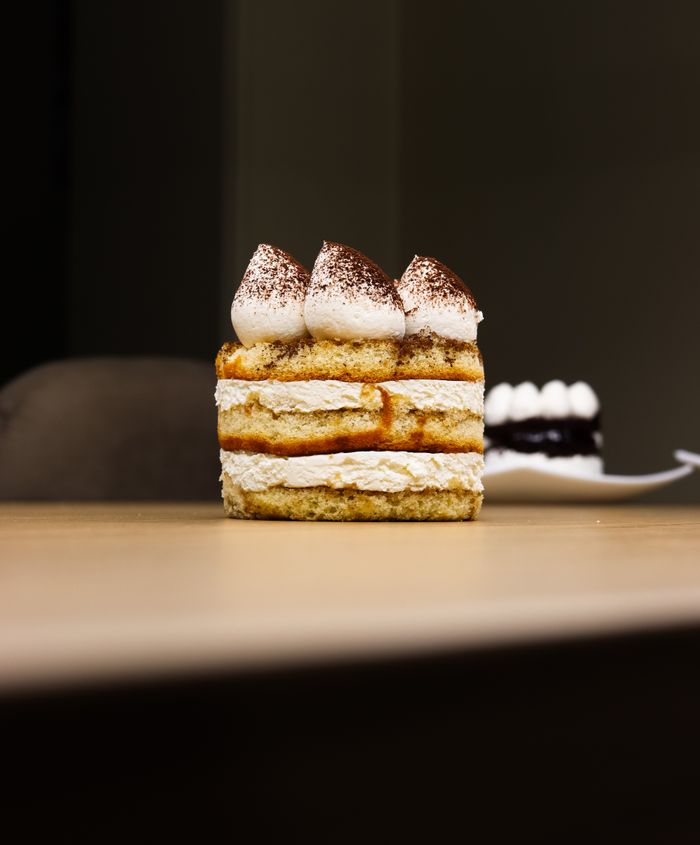 A slice of tiramisu on a wooden table