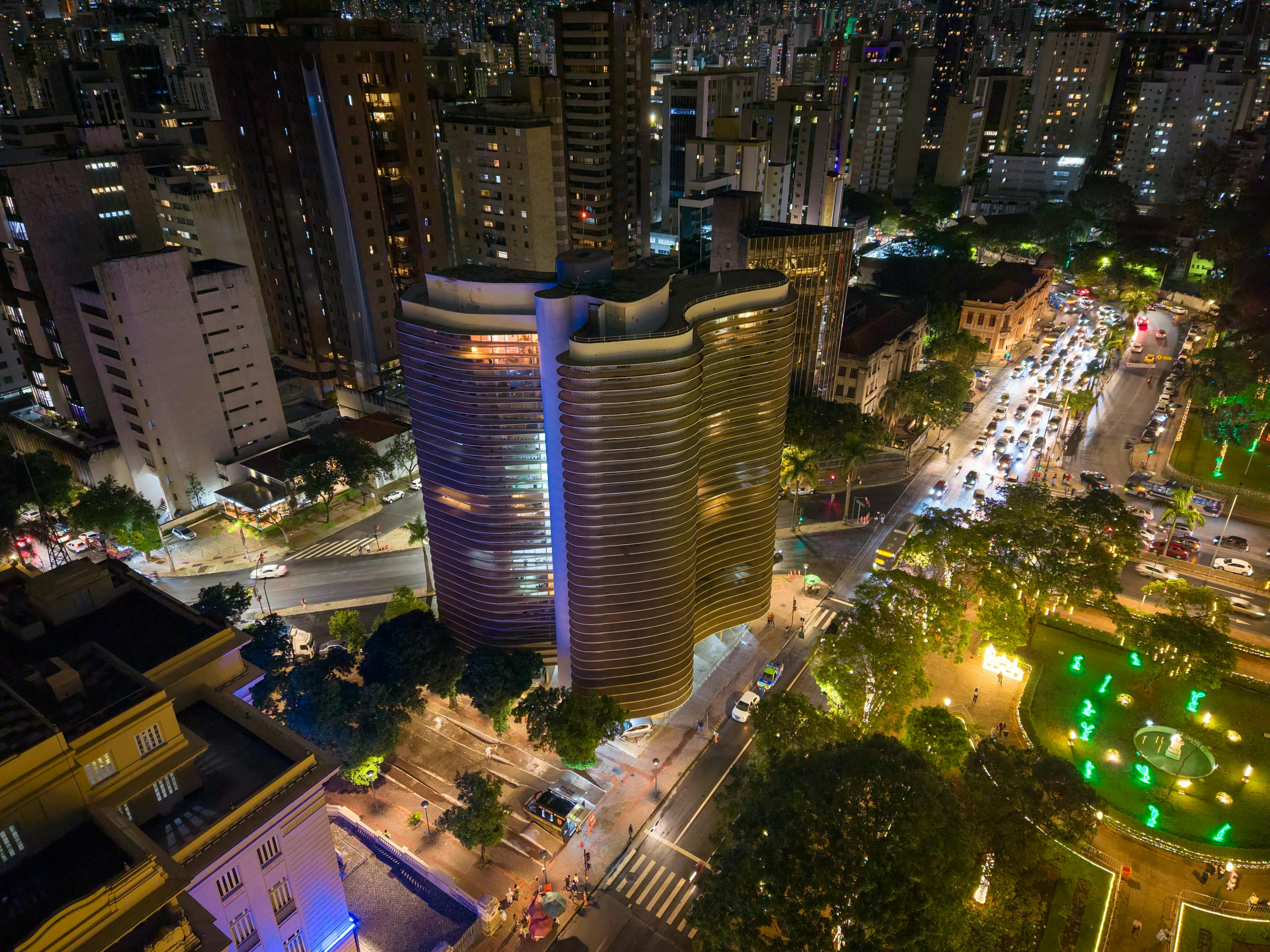 A breathtaking aerial view of Belo Horizonte at night featuring illuminated modern architecture and vibrant city lights.