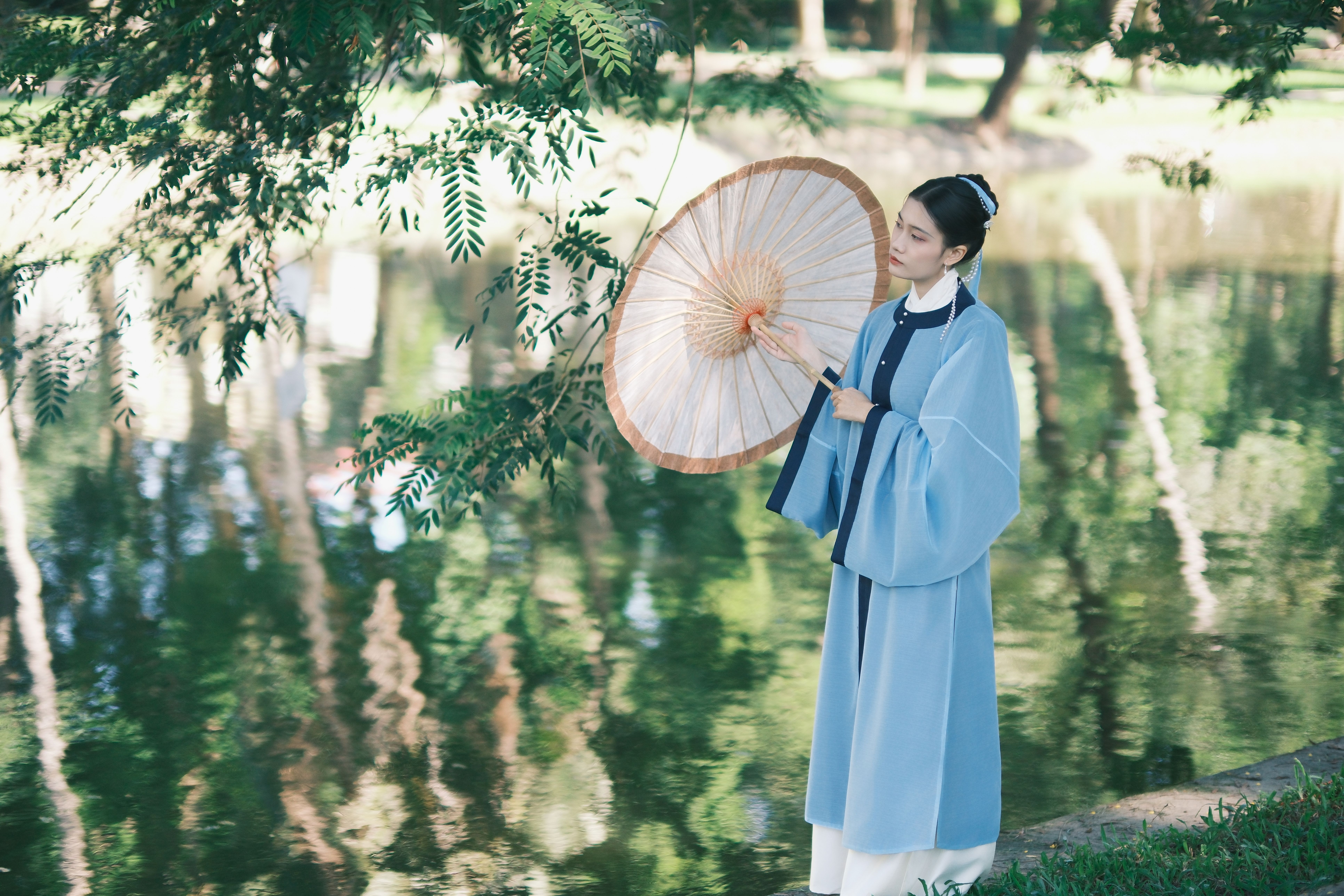 Elegant Woman in Traditional Dress by Pond · Free Stock Photo