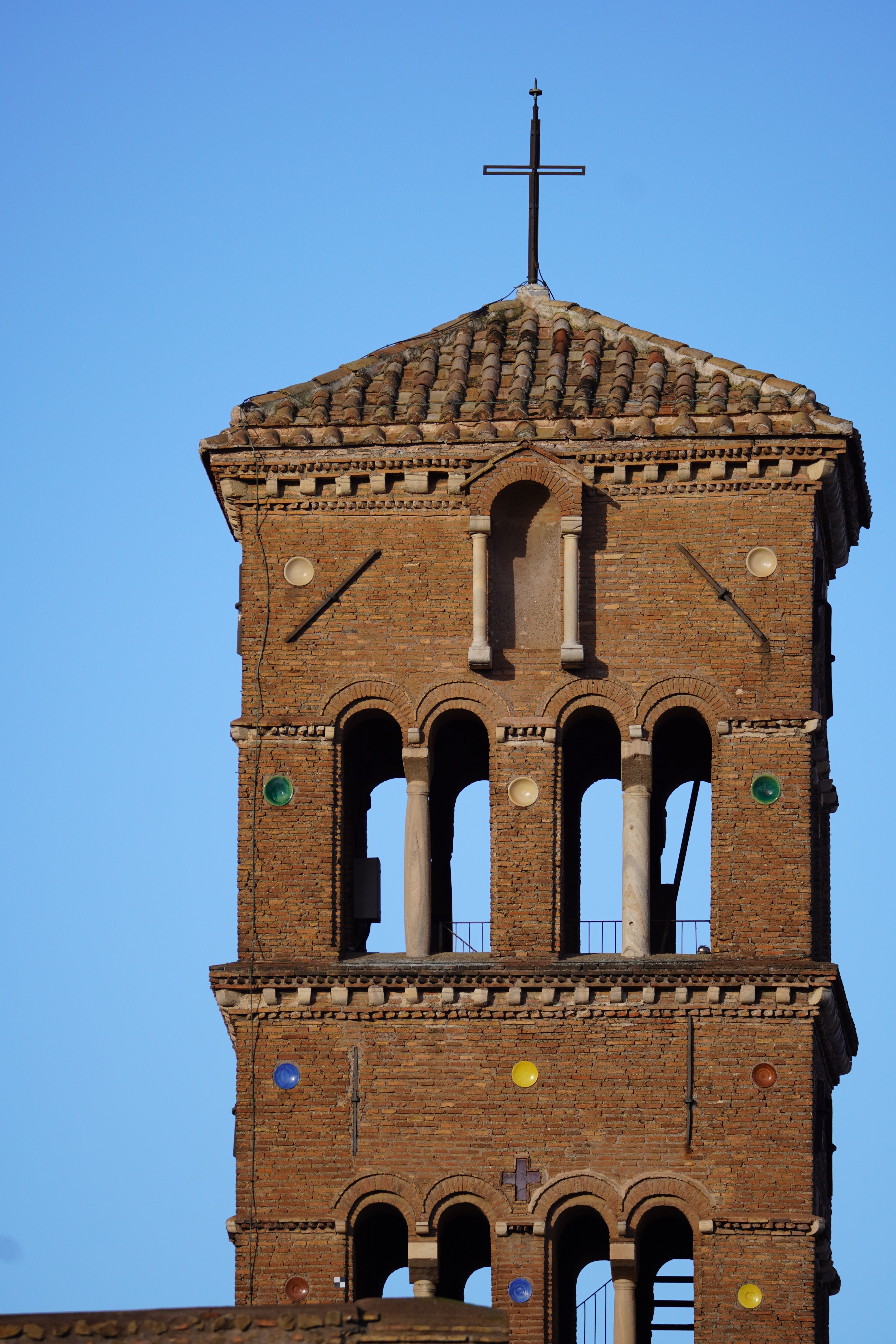 A close-up view of the ancient bell tower of Santi Giovanni e Paolo in Rome, Italy.