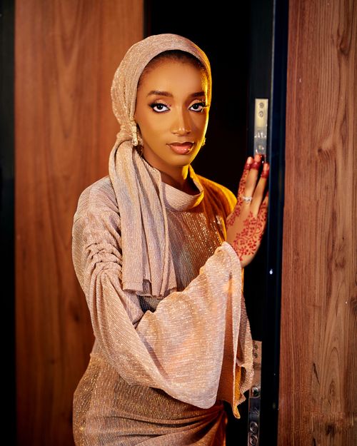 Free Portrait of a woman in a shimmering outfit with henna designs, posing elegantly. Stock Photo